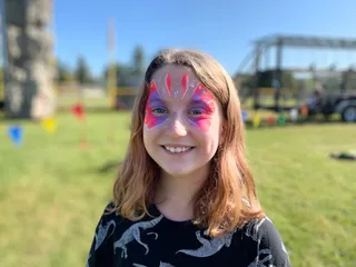 Child with pink butterfly facepaint